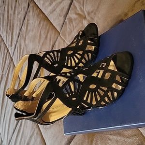 Lace cut out black suede-like peep toe heels.